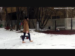 hardened and confident girl walks barefoot in winter