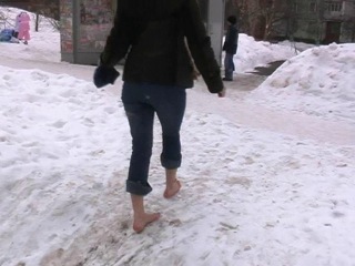 alena takes a barefoot walk in the winter city. part 1/3.